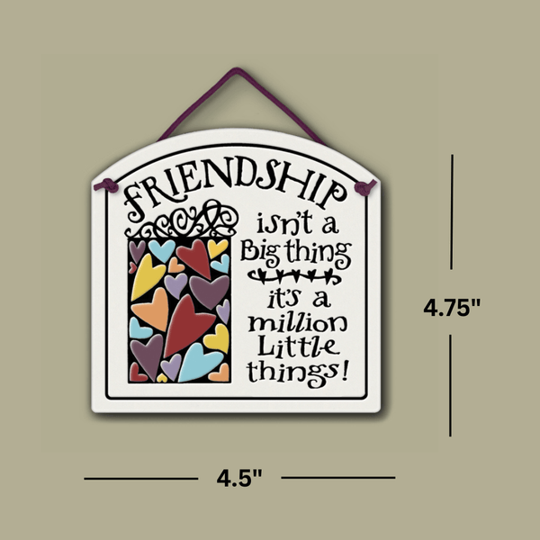 Ceramic wall tile with colorful hearts and the quote ‘Friendship isn’t a big thing, it’s a million little things,’ shown with dimensions 4.75 inches tall and 4.5 inches wide.