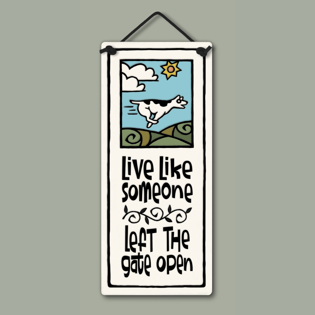 Spooner Creek small tall ceramic plaque with quote “Live like someone left the gate open,” playful running dog artwork with sun and clouds, handcrafted hanging décor, 2.75 x 6.75 inches.