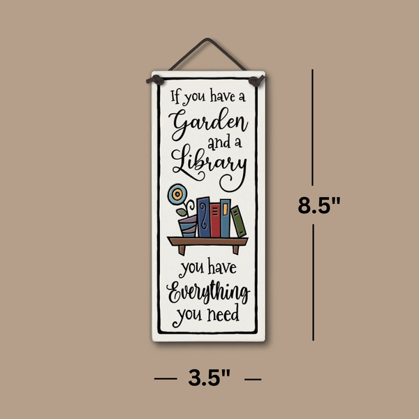 Handcrafted Spooner Creek tall ceramic tile with the quote “If you have a garden and a library you have everything you need,” shown with 3.5x8.5 inch dimensions and colorful book-and-flower artwork.
