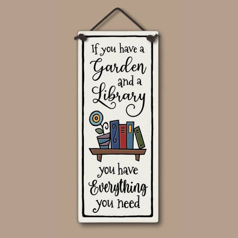 Handcrafted Spooner Creek tall ceramic tile with the quote “If you have a garden and a library you have everything you need,” featuring colorful books and a flower pot, 3.5x8.5 inch wall art.