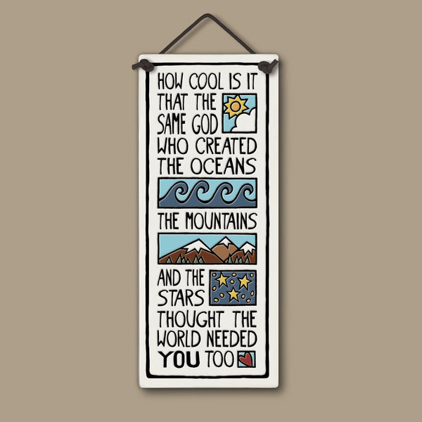 Handcrafted Spooner Creek tall ceramic tile with the quote “How cool is it that the same God who created the oceans, the mountains, and the stars thought the world needed you too,” featuring waves, mountains, stars, and sunrise illustrations, 3.5x8.5 inch inspirational wall art.