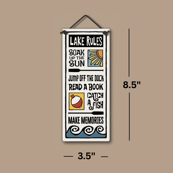 Lake Rules ceramic wall tile with colorful icons and text, measuring 8.5 by 3.5 inches.