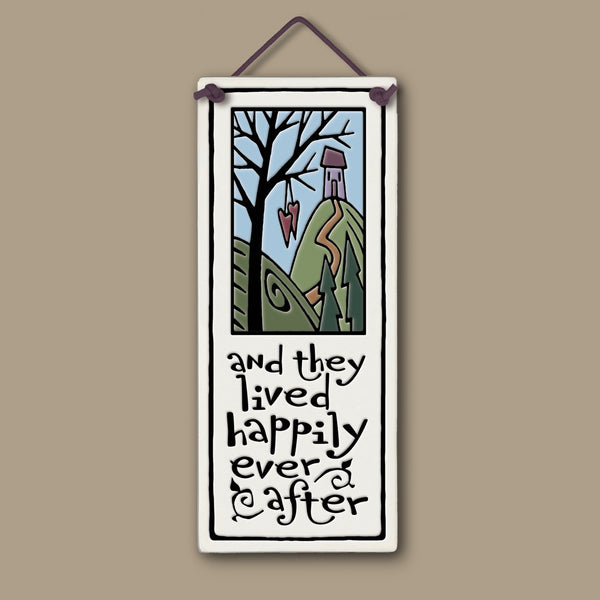 Spooner Creek large tall ceramic tile with the quote “and they lived happily ever after,” featuring a whimsical cottage on a hill, hanging hearts, and pastel nature artwork; handcrafted wall décor measuring 3.5 x 8.5 inches.