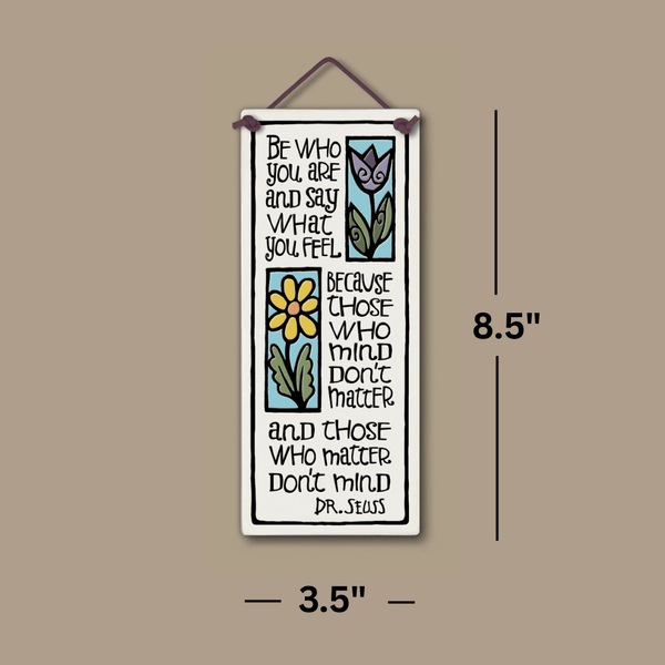 Spooner Creek large tall ceramic tile, 3.5 x 8.5 inches, featuring quote “Be who you are and say what you feel” with purple and yellow floral artwork, hanging against a neutral background with labeled dimensions.