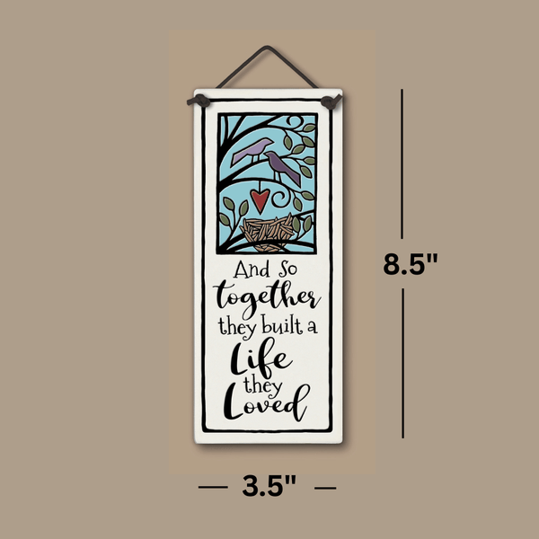 Spooner Creek ceramic tall tile – “And so together they built a life they loved” quote, 3.5x8.5 inch wall art with two birds, heart, and nest illustration, hanging home décor, product dimensions shown.