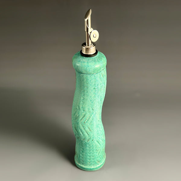 Green handmade stoneware olive oil cruet with curved pour spout, ceramic oil dispenser by Macone Clay, functional kitchen accessory for cooking and gifting