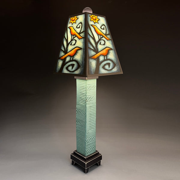 Birds in Tree handmade ceramic table lamp with gray stoneware base, vivid orange birds and glowing sun shade by Michael Macone, made in Shell Lake Wisconsin