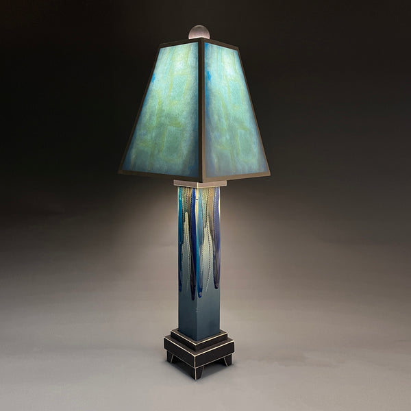 Blue Shade handmade ceramic table lamp with straight blue extruded clay base and melted glass drip finish, luminous aqua and teal glowing shade by Macone Clay, made in Shell Lake Wisconsin