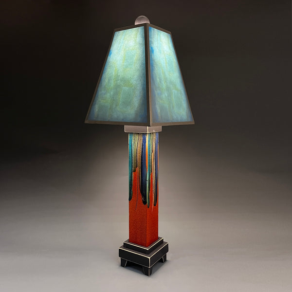 Blue Shade handmade ceramic table lamp with straight red extruded clay base, glowing teal and aqua shade by Macone Clay, made in Shell Lake Wisconsin