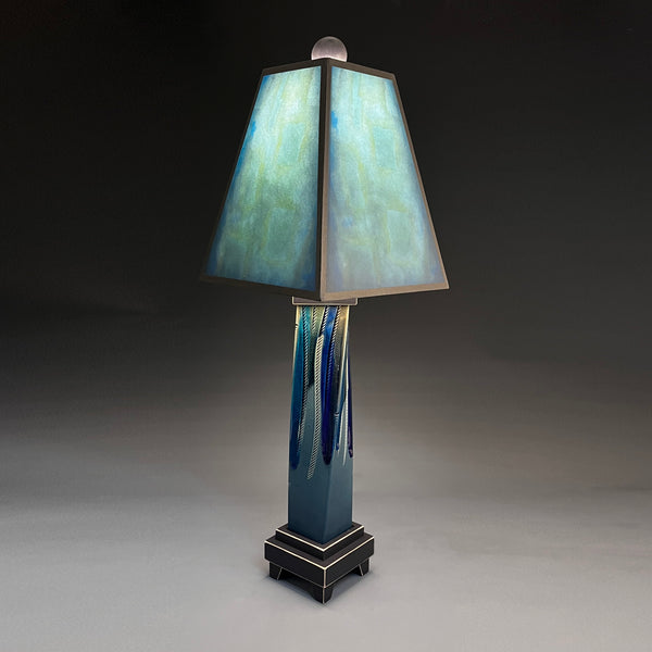 Blue Shade handmade ceramic table lamp with twisted blue extruded clay base, luminous aqua and teal glowing shade by Macone Clay, made in Shell Lake Wisconsin