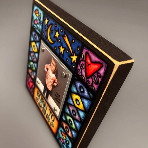 Corner detail of Born To Shine quote picture frame featuring colorful Michael Macone artwork with stars, hearts, and floral accents