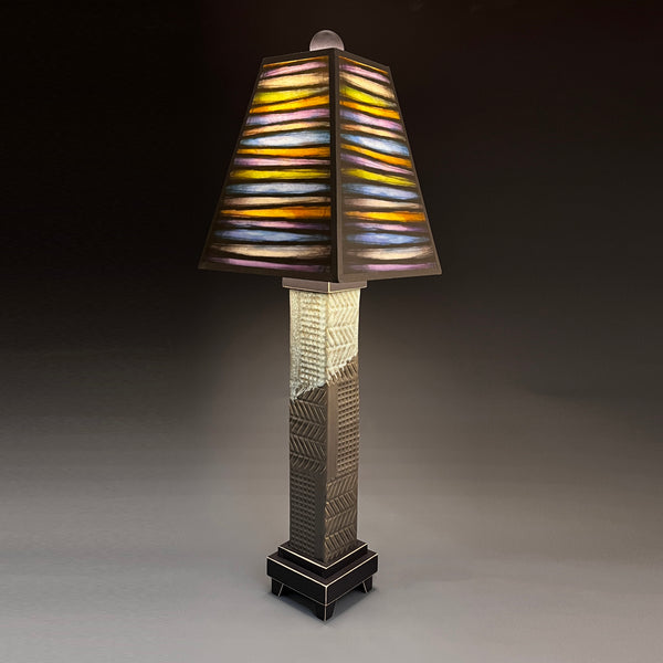 Bright Stripes handmade ceramic table lamp with gray stoneware base, glowing multicolor striped shade by Michael Macone, made in Shell Lake Wisconsin