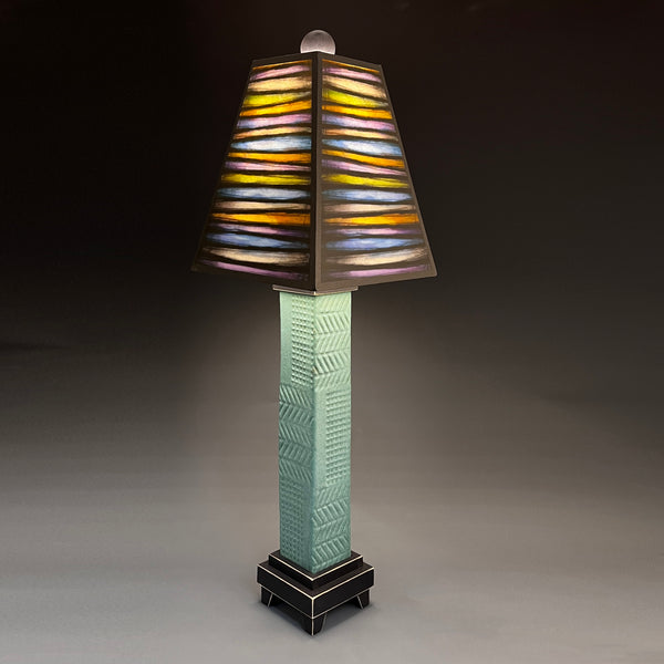 Bright Stripes handmade ceramic table lamp with green stoneware base, bold yellow orange and blue striped art shade by Michael Macone, made in Shell Lake Wisconsin