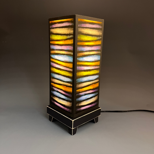 Bright Stripes mood lamp lit and glowing on white background