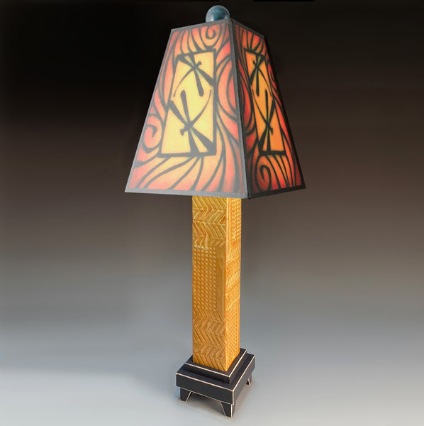 Brown Dragonfly handmade ceramic table lamp with brown stoneware base, bold dragonfly art shade glowing in warm reds and orange by Michael Macone, made in Shell Lake Wisconsin