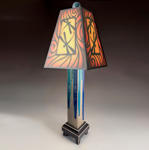 Brown Dragonfly handmade ceramic table lamp with gray glass finish base, glowing warm red and gold dragonfly shade by Michael Macone, made in Shell Lake Wisconsin