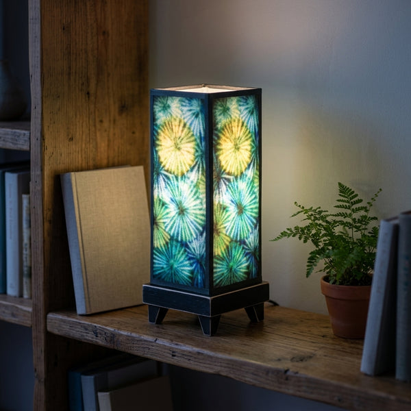 Carved Circles mood lamp glowing on a living room shelf