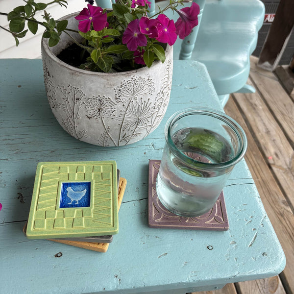 Handmade lime green ceramic chicken coaster with crazed glass center styled with a mug on a matching ceramic coaster by Macone Clay.