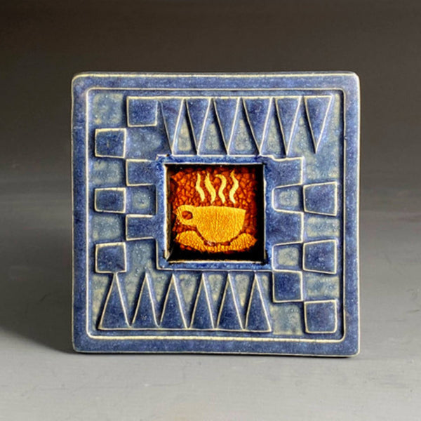 Handmade blue ceramic coffee cup coaster with crazed glass center and carved geometric border by Macone Clay