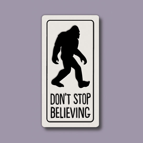 Funny Sasquatch quote ceramic magnet with Bigfoot silhouette and “Don’t stop believing,” handmade Spooner Creek magnet made in the USA