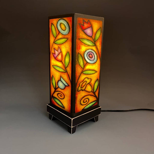 Flowers mood lamp lit with room lights off, showing stained-glass floral glow