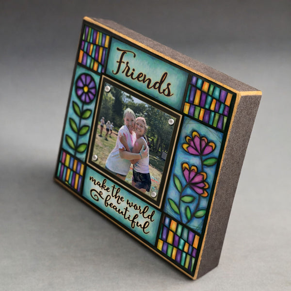 Corner detail of Friends make the world beautiful quote friend picture frame highlighting colorful Michael Macone floral stained glass style artwork