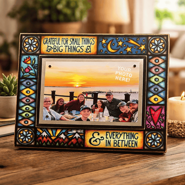 Grateful for small things big things stained glass style picture frame on wood table with sunset family photo and cozy home decor background