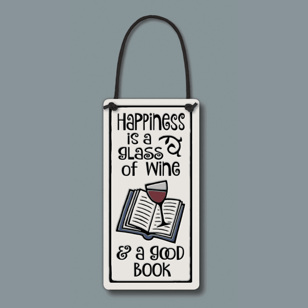 Ceramic Spooner Creek wine tag reading “Happiness is a glass of wine and a good book,” handmade gift for wine lovers and book lovers, hanging on bottle