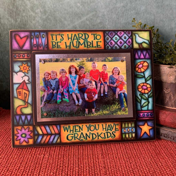 Grandkids picture frame with the quote It’s hard to be humble when you have grandkids displayed on shelf showing colorful artwork and 4x6 grandkids photo.