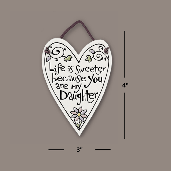 Heart shaped Spooner Creek mini charmer showing 3 by 4 inch size, handmade ceramic tile with sentimental daughter quote and leather like cord hanger.