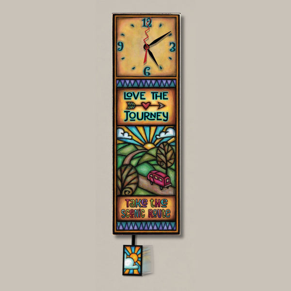 Love the Journey wood wall clock, a tall rectangular art clock with a scenic road, van, and sunrise design, featuring a travel-themed quote