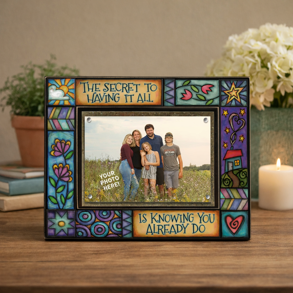Macone Clay The Secret to Having It All inspirational picture frame displayed on wood table with candle and greenery, holding a 4x6 family photo