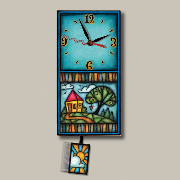Home small wood wall clock by Michael Macone with a turquoise face, yellow house and swirly tree artwork, and a swinging sun pendulum