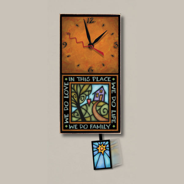 We Do Family small wood wall clock by Michael Macone with the quote In This Place We Do Life, We Do Family, We Do Love, and a sunburst pendulum