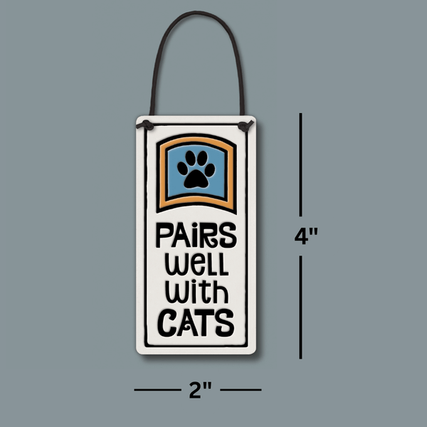 Ceramic wine bottle tag measuring 2 x 4 inches with “Pairs well with cats” quote, handmade Spooner Creek wine tag