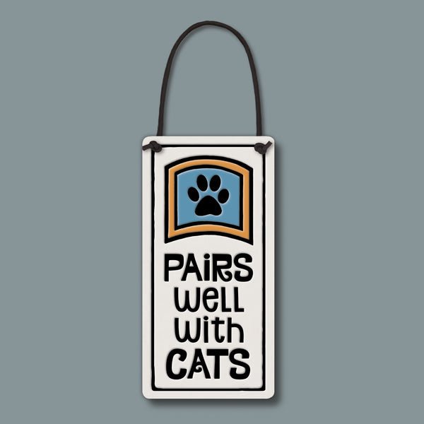 Ceramic wine bottle tag with paw print and “Pairs well with cats” quote, handmade Spooner Creek wine tag with black cord