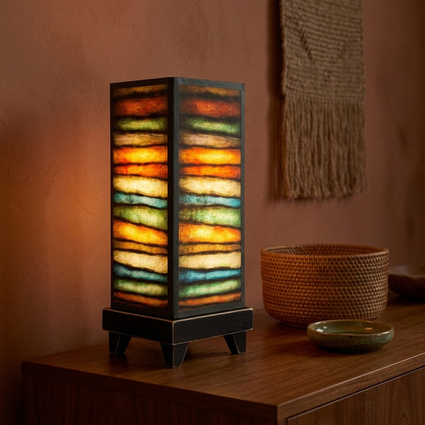 Rough Stripes mood lamp glowing on a living room console table