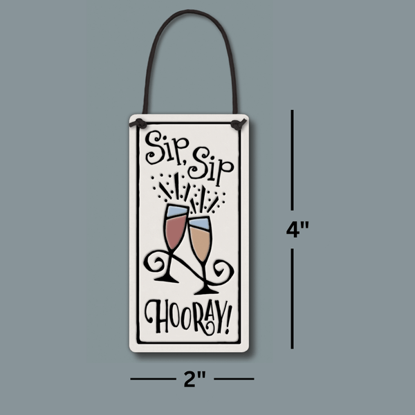 Size reference image showing Spooner Creek Sip Sip Hooray ceramic wine tag measuring 2 x 4 inches with leather like cord for hanging.