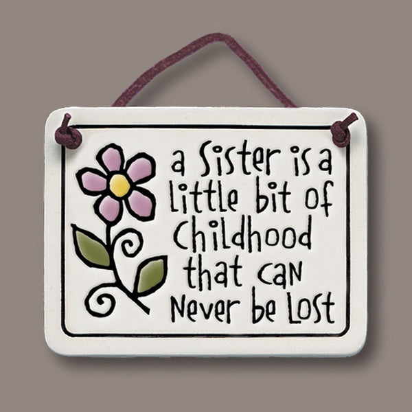 Handmade Spooner Creek Mini Charmer ceramic tile featuring the quote “A sister is a little bit of childhood that can never be lost,” a sentimental gift for sisters.