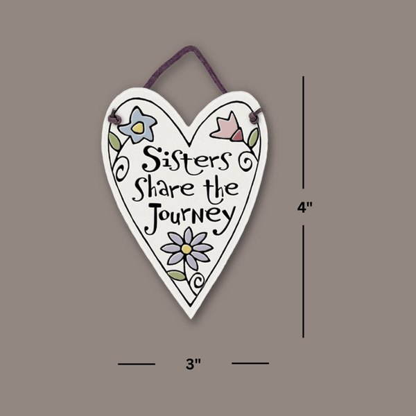 Heart shaped Spooner Creek mini charmer showing 3 by 4 inch size, handmade ceramic tile with sister quote and leather like cord hanger.