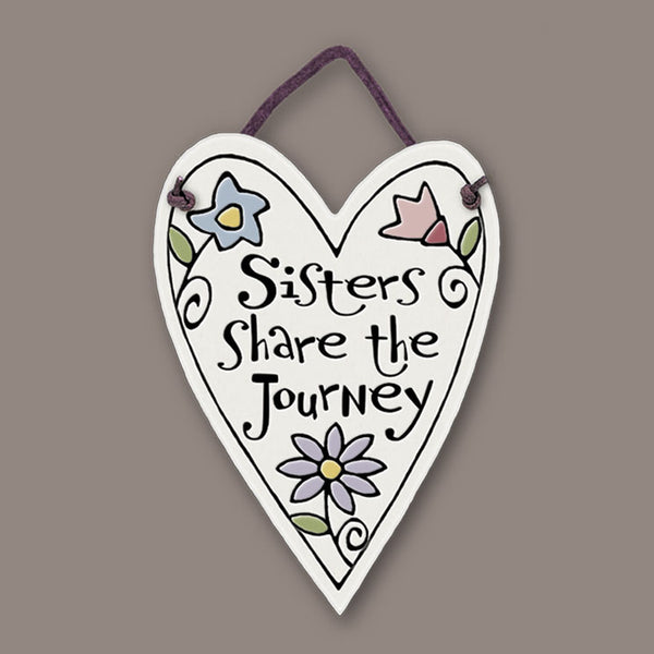 Heart shaped ceramic mini charmer with the quote “Sisters share the journey,” a handmade Spooner Creek keepsake gift celebrating sisterhood and family bonds.