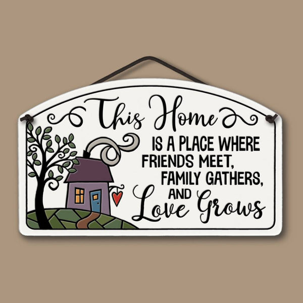 Spooner Creek large arch ceramic tile wall decor featuring a house and tree illustration with the quote this home is a place where friends meet, family gathers, and love grows