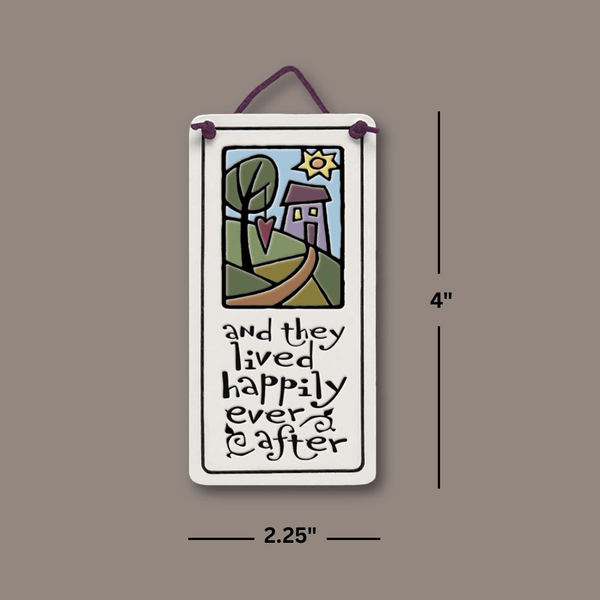 Dimensions of Spooner Creek Mini Charmer ceramic tile measuring 2.25 by 4 inches, featuring the quote And they lived happily ever after and leather like cord.