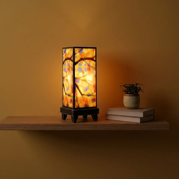 Stained Tree mood lamp glowing on a floating shelf in a living room