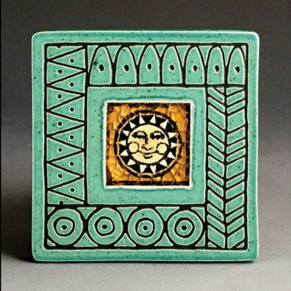 Handmade turquoise ceramic sun face coaster with crazed glass center and carved geometric border by Macone Clay