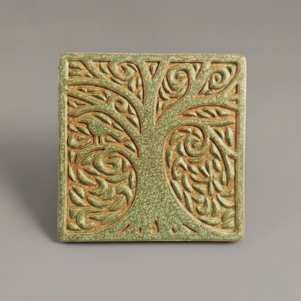 Handmade sage green ceramic tree coaster with deeply carved botanical design by Macone Clay