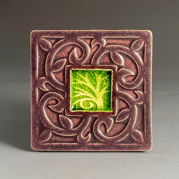 Handmade plum ceramic tree coaster with crazed glass center and carved scrollwork border by Macone Clay