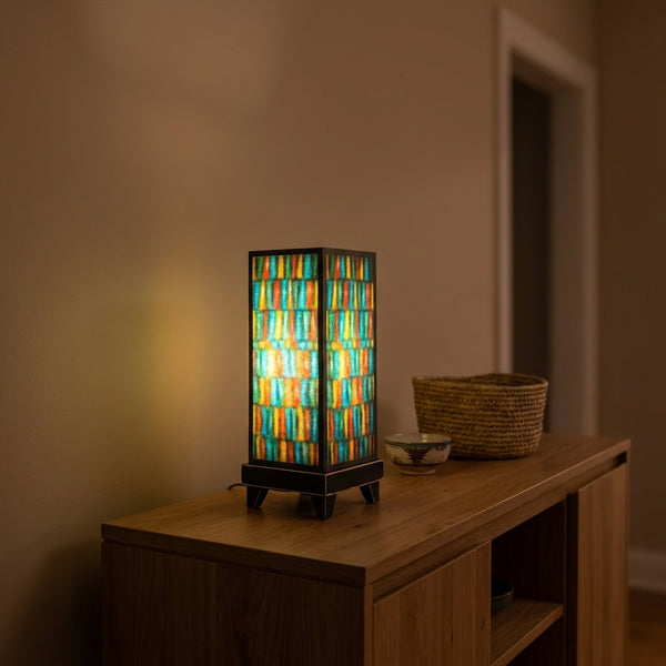 Vertical Stripes mood lamp glowing on a living room console table
