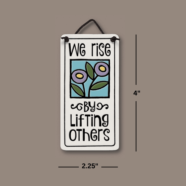 Dimensions of Spooner Creek We Rise By Lifting Others mini charmer ceramic tile showing 4 inch height and 2.25 inch width with floral artwork and hanging cord