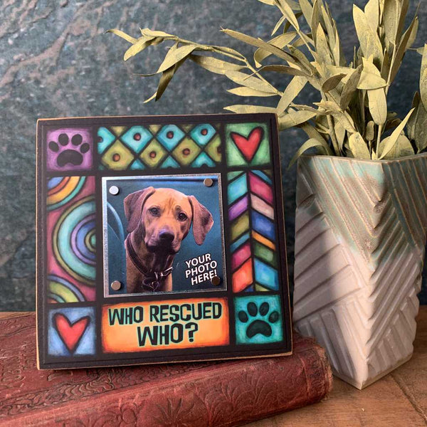 Who rescued who pet picture frame displayed on shelf showing colorful Michael Macone dog lover artwork with magnetic square photo display